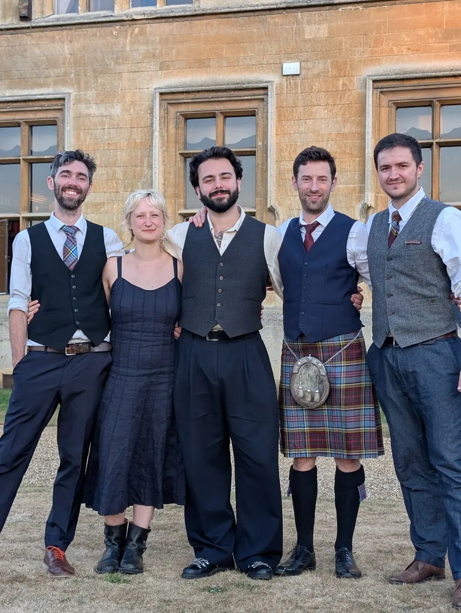 Band portrait outside a stately home
